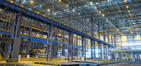 The interior of a big industrial building or factory with steel constructions