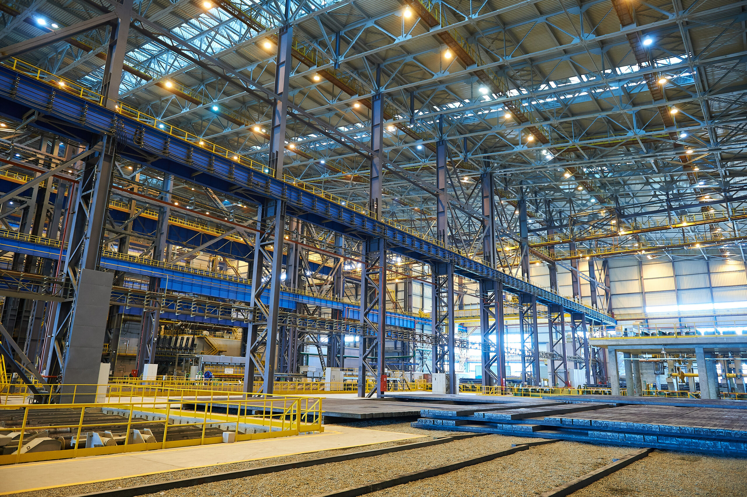 The interior of a big industrial building or factory with steel constructions